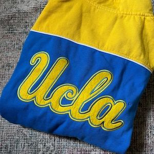 UCLA Bruins blue, yellow, and white quarter zip with “UCLA” on the back